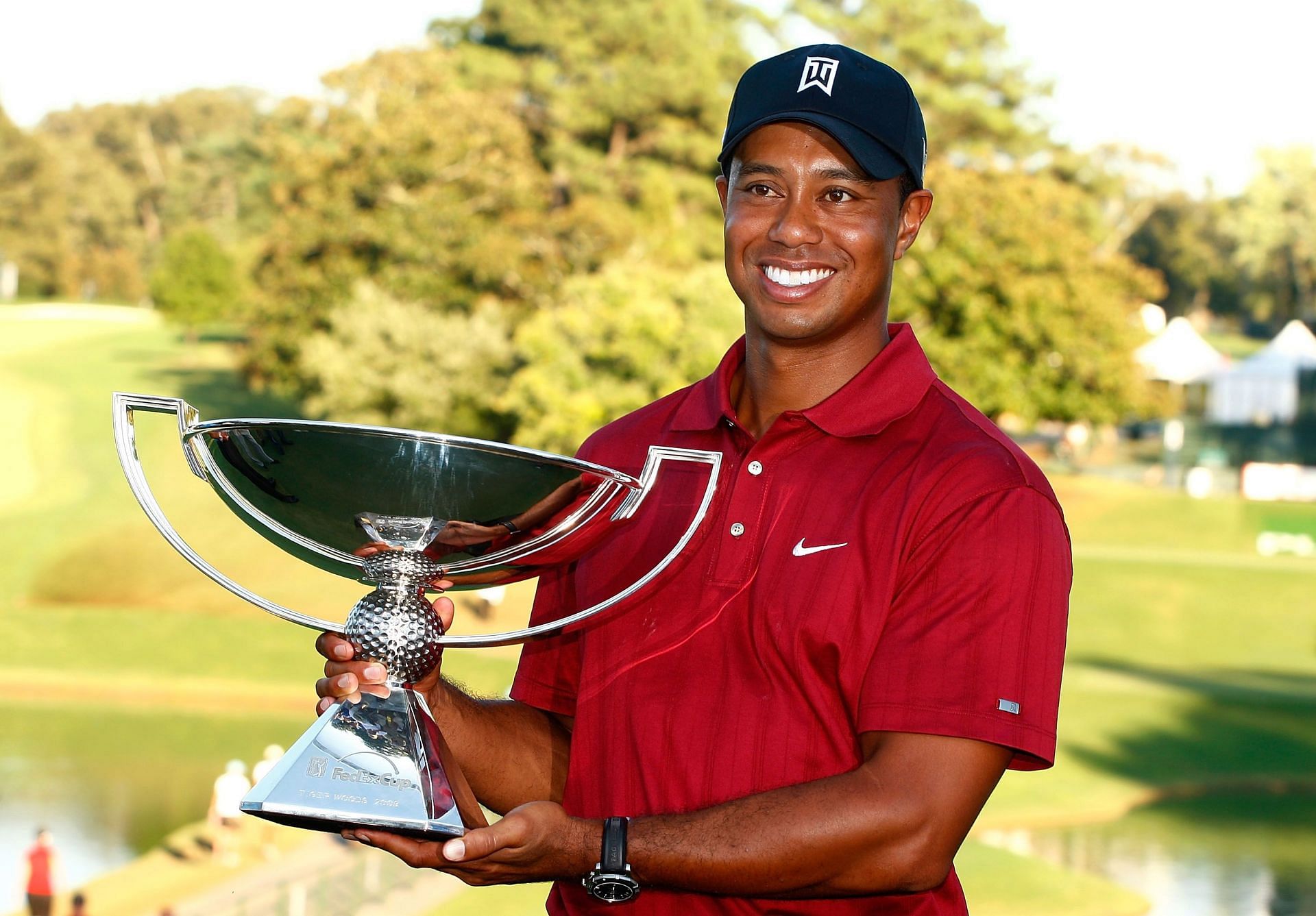 Tiger Woods poses with the 2009 FedEx Cup after the final round of The Tour Championship