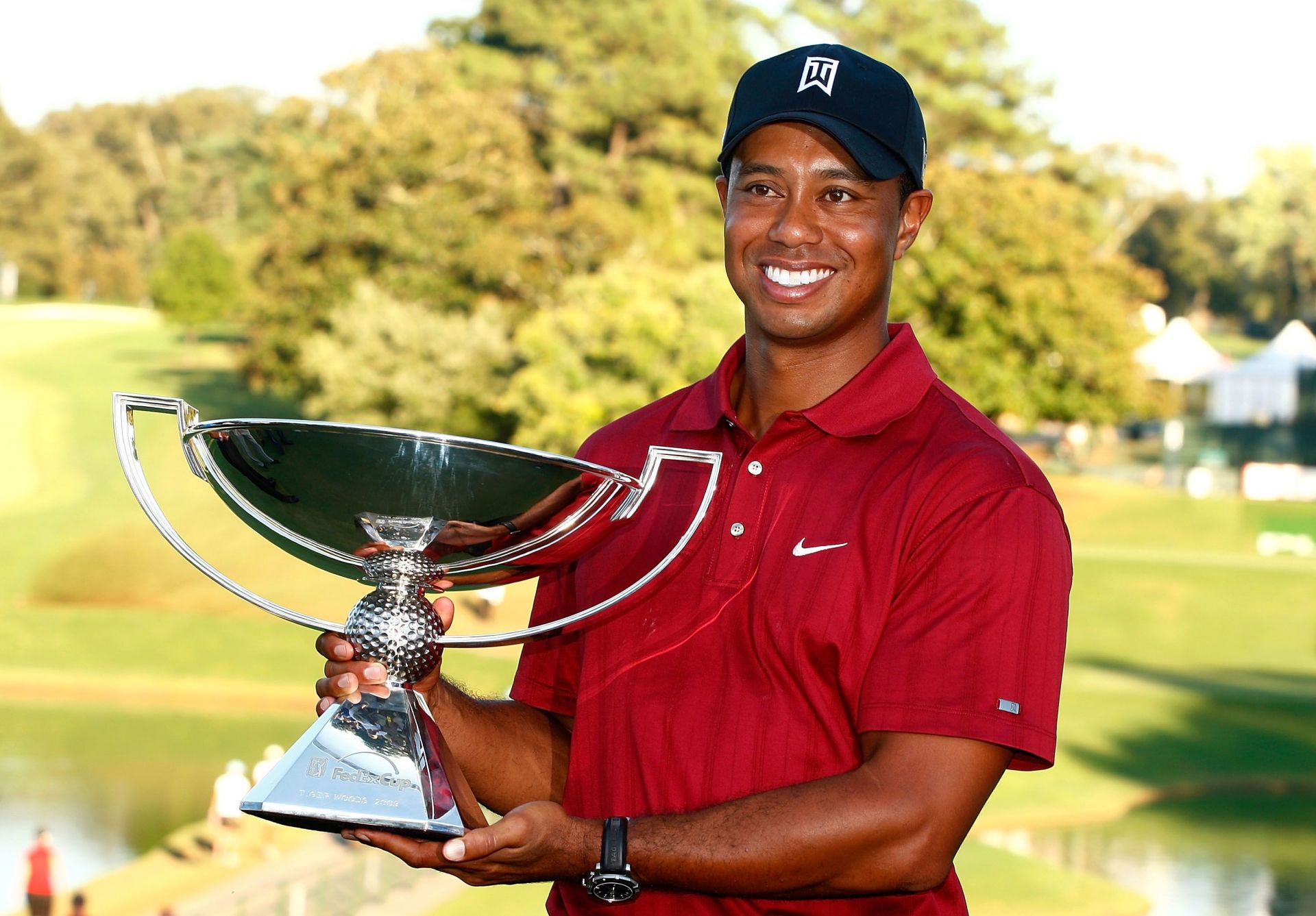 Tiger Woods poses with the 2009 FedEx Cup after the final round of The Tour Championship