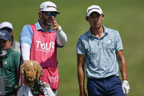 Collin Morikawa speaks to his caddie on the seventh fairway during the second round of the Tour Championship