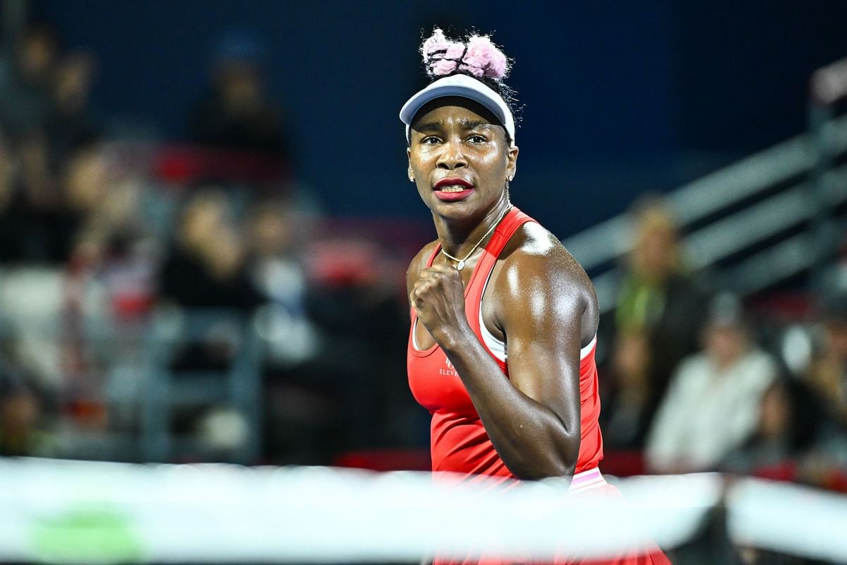 Venus Williams dons red lipstick to go with her bright red fit in ...