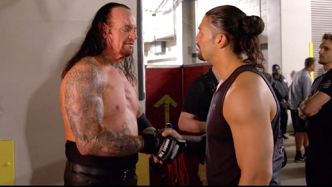 Two top stars, The Undertaker and Roman Reigns, shaking hands backstage