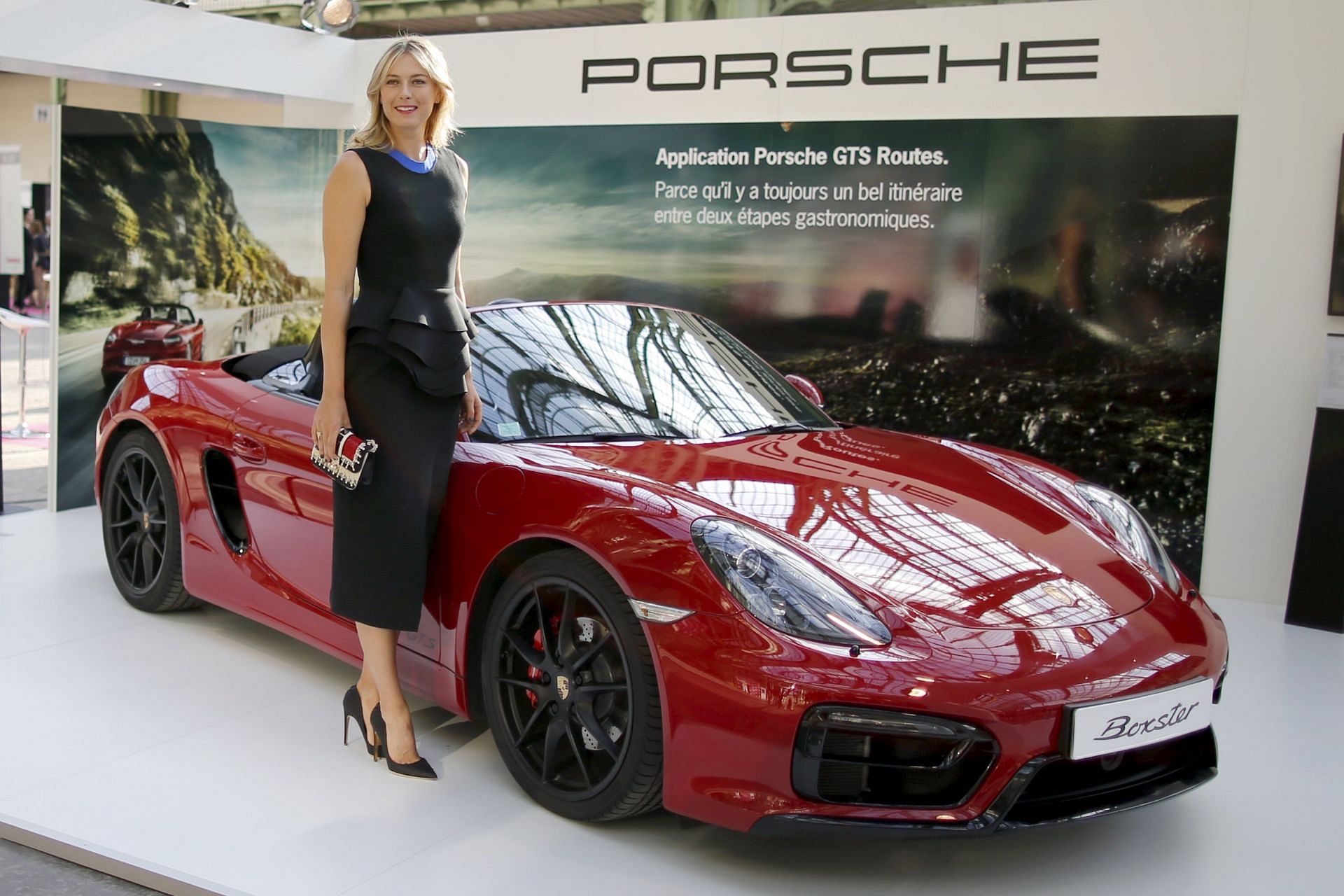 Maria Sharapova poses with a top Porsche model