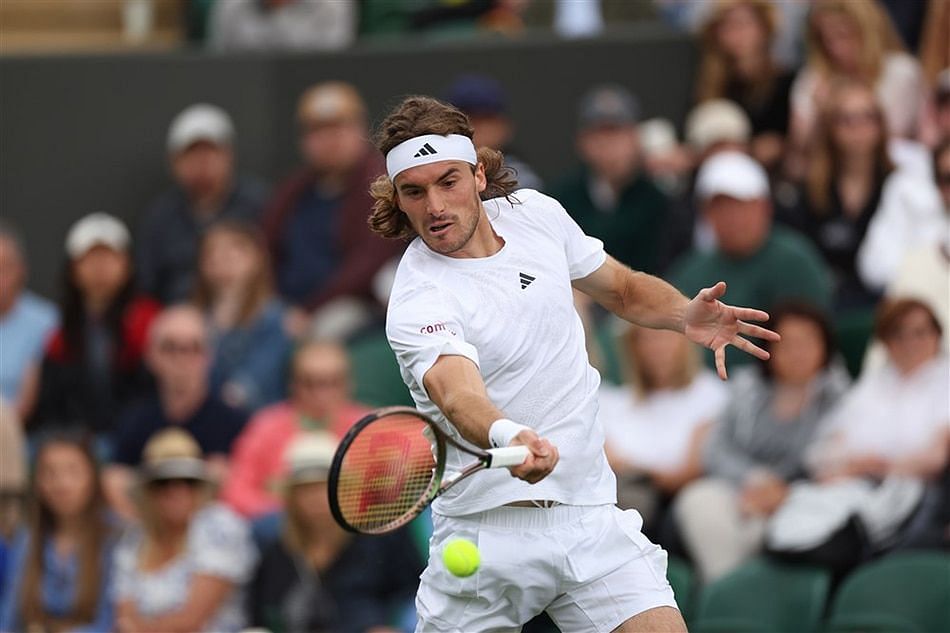 Stefanos Tsitsipas hits a forehand at 2023 Wimbledon