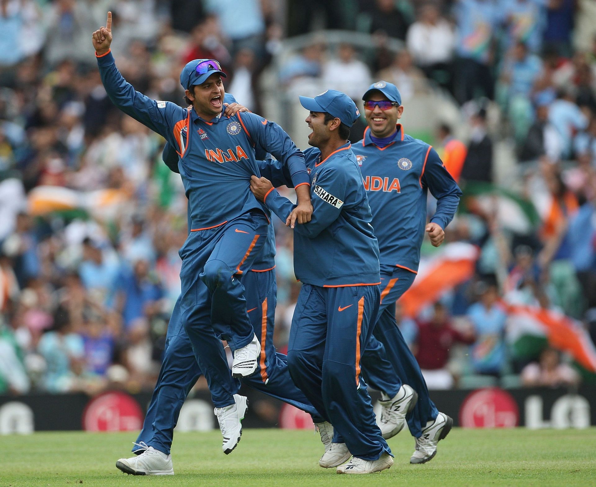 Suresh Raina celebrating a run-out with his teammates [Getty Images]