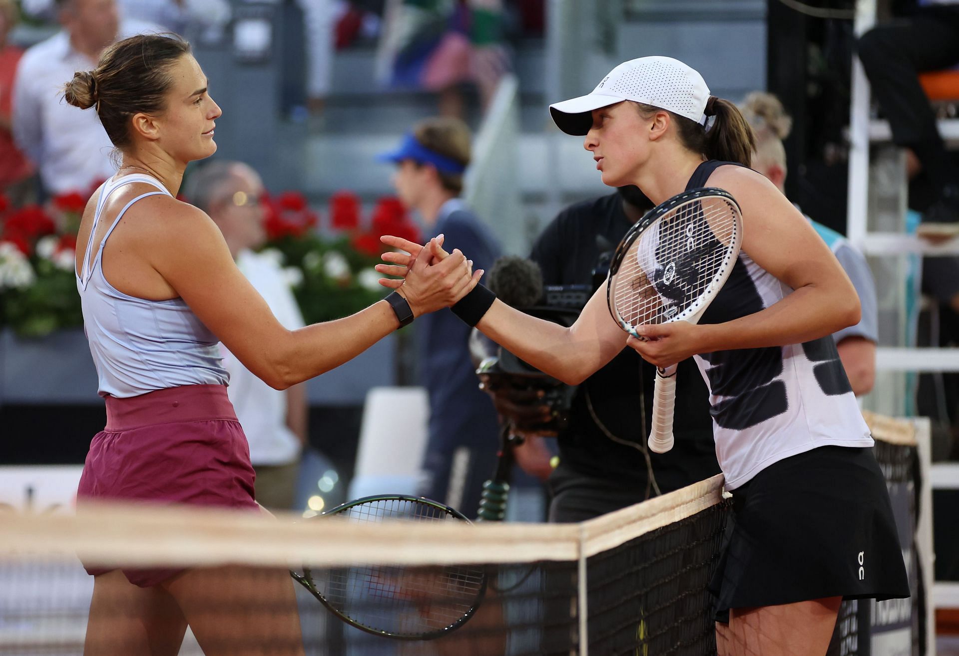 Aryna Sabalenka and Iga Swiatek greet each other.