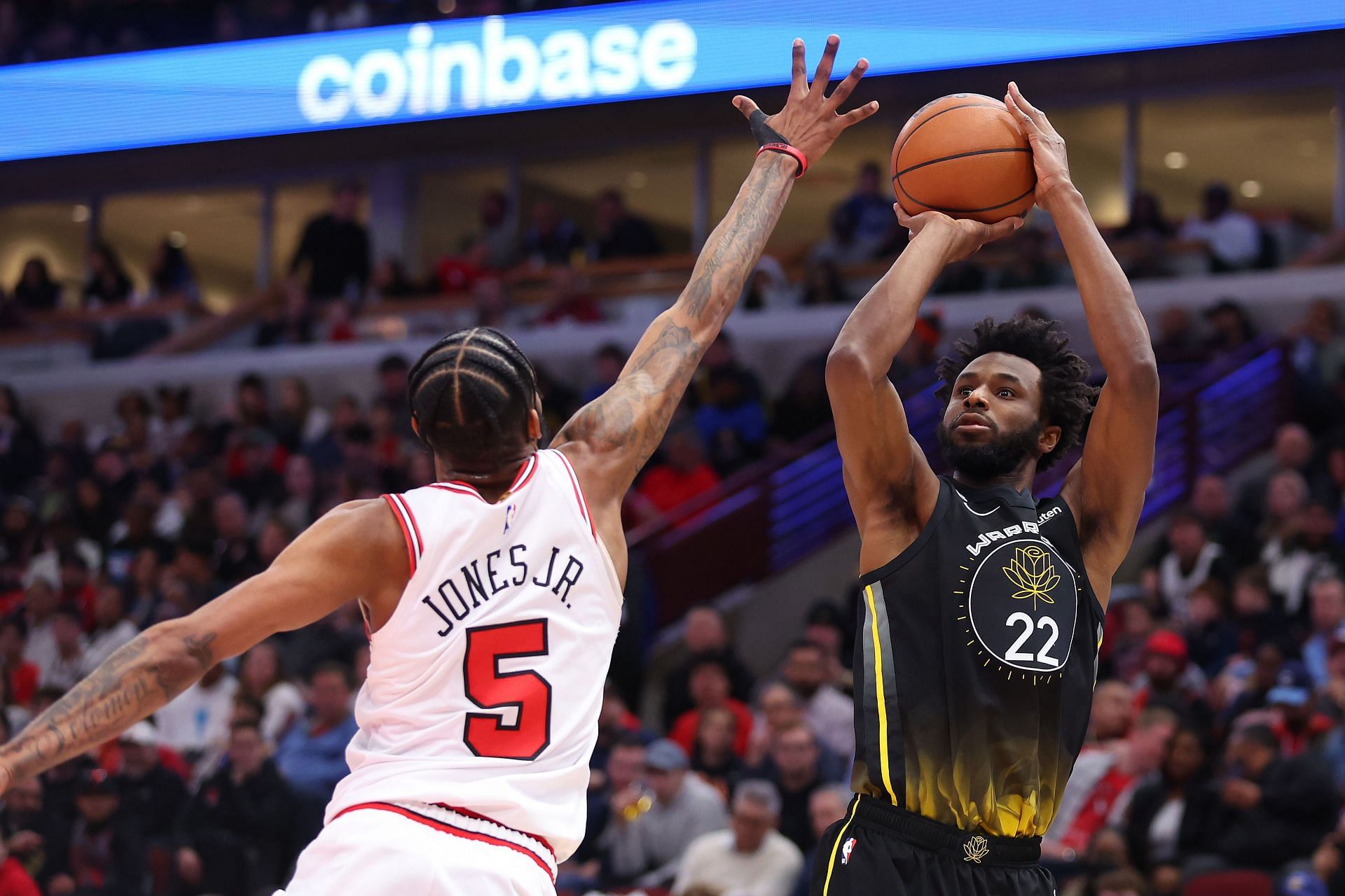 Former Chicago Bulls forward Derrick Jones Jr. attempting to block Golden State Warriors forward Andrew Wiggins&#039; shot attempt