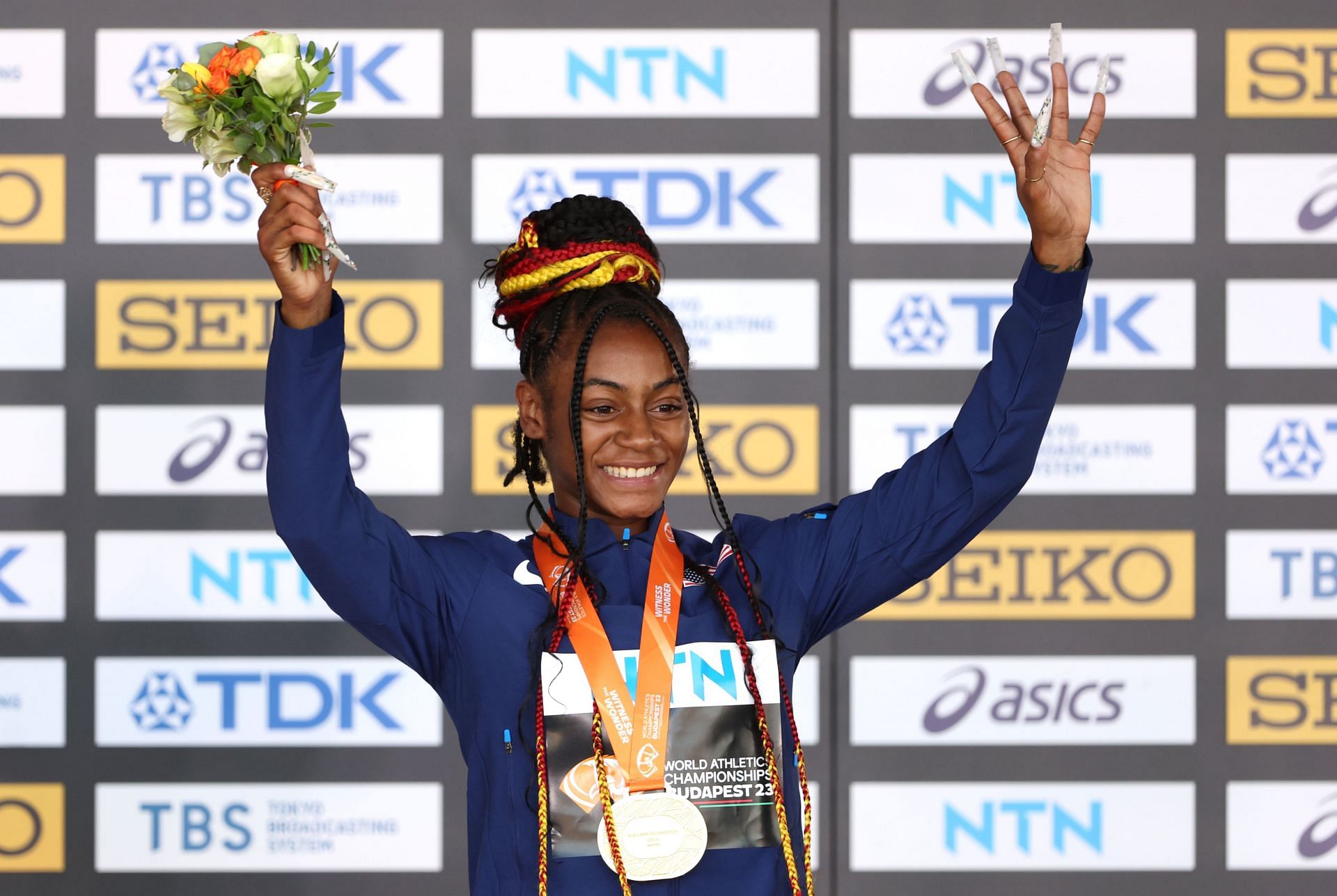 Sha&#039;Carri Richardson poses on the podium during the medal ceremony for the women&#039;s 100m at the 2023 World Athletics Championships in Budapest, Hungary