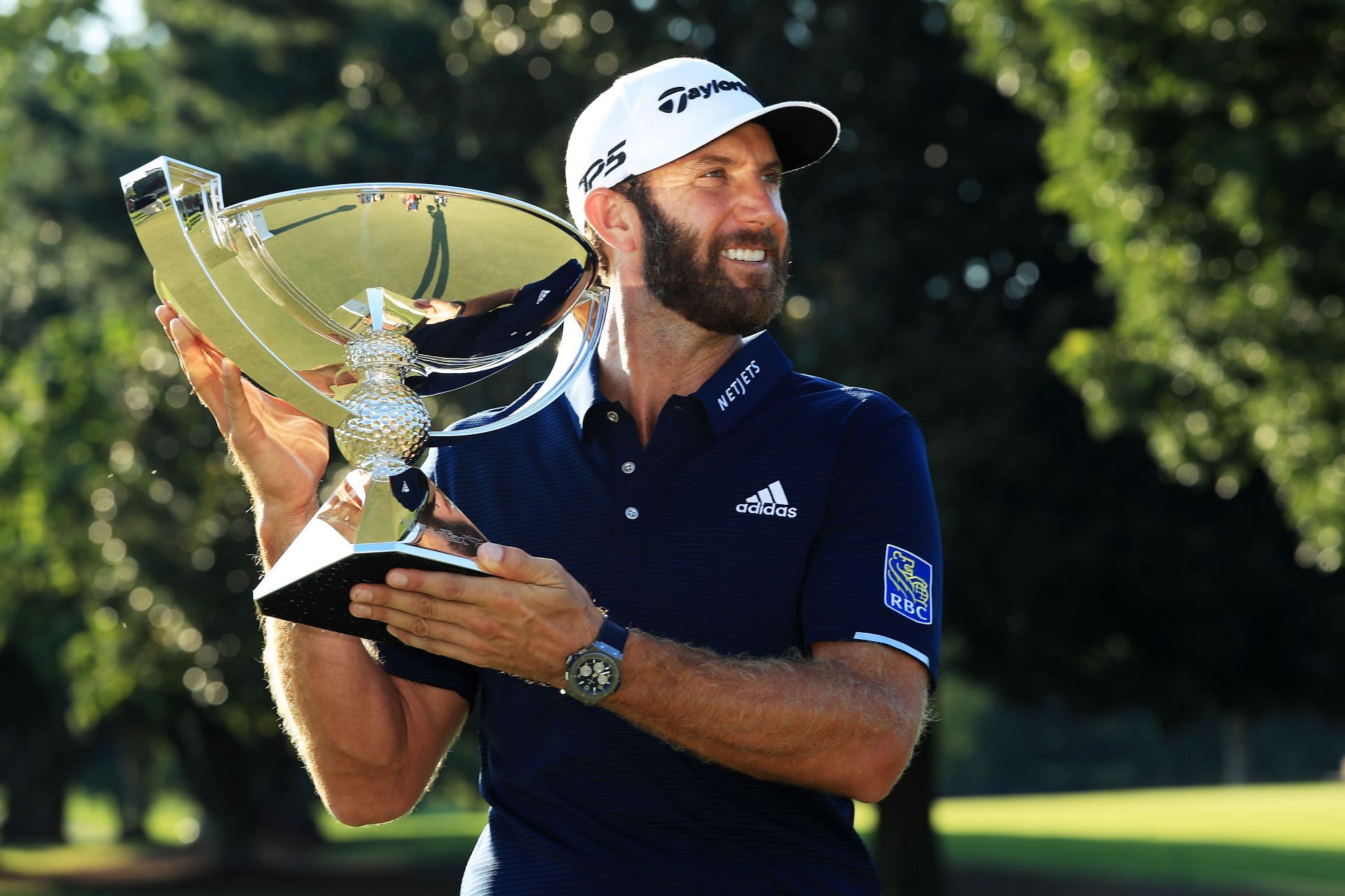 Dustin Johnson poses after winning the 2020 Tour Championship