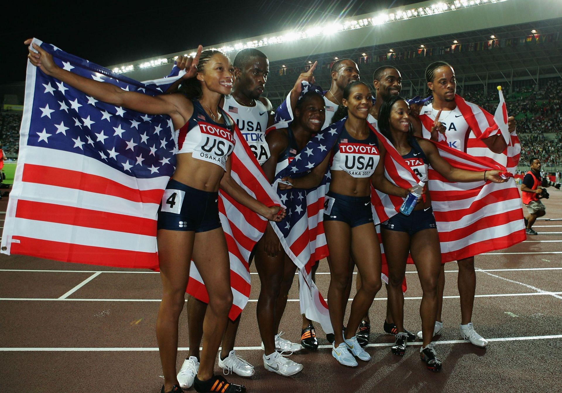 Allyson Felix, Leroy Dixon, Lauryn Williams, Darvis Patton, Torri Edwards, Tyson Gay, Mikele Barber, and Wallace Spearman celebrate after winning the men&#039;s and women&#039;s 4x100m relay at the 2007 IAAF World Athletics Championships in Osaka, Japan