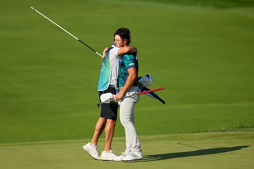 Viktor Hovland and Shay Knight hug at the BMW Championship (Image via Getty)