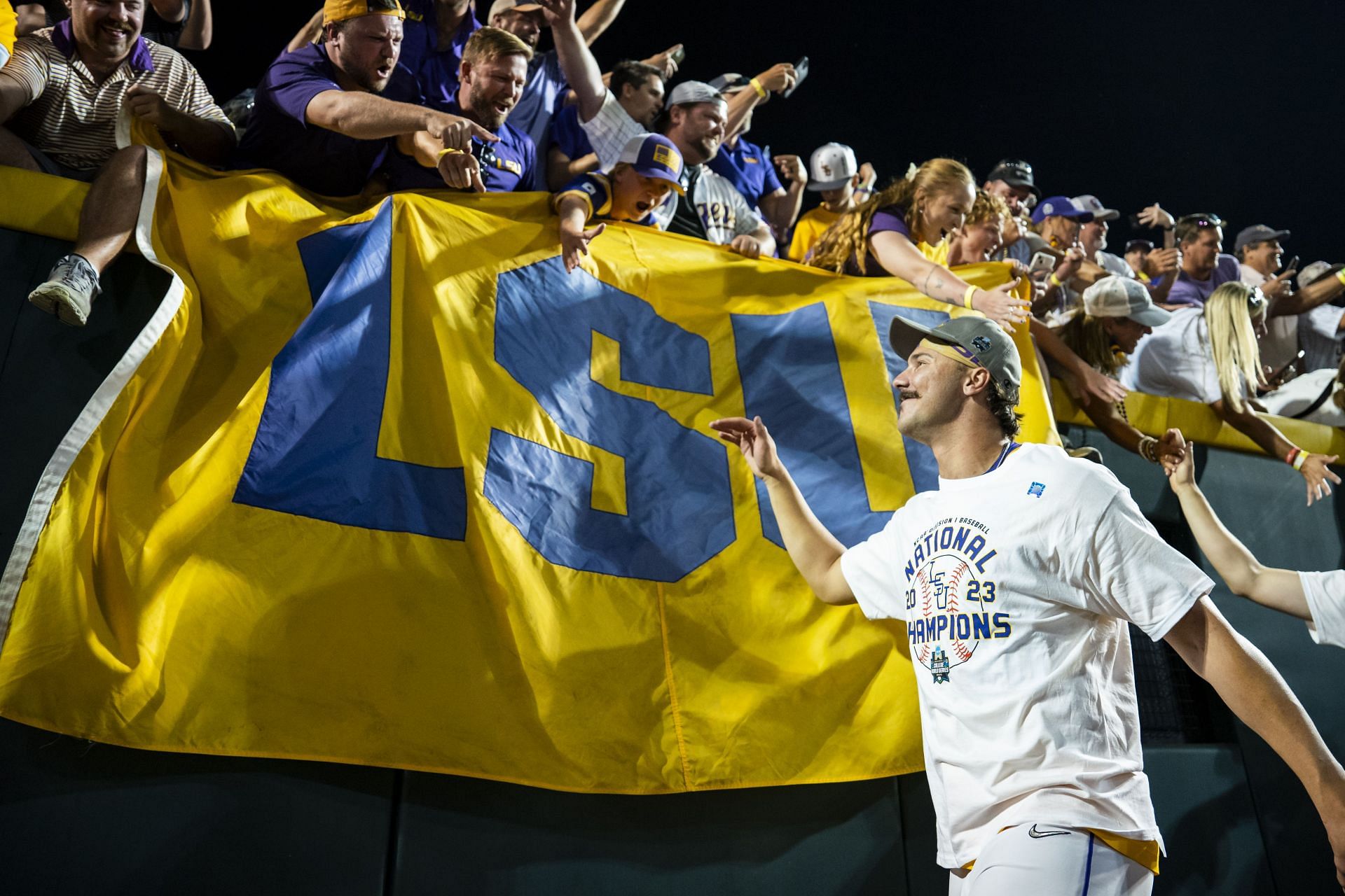 Paul Skenes #20 of the LSU Tigers greets fans after winning the NCAA College World Series in Omaha
