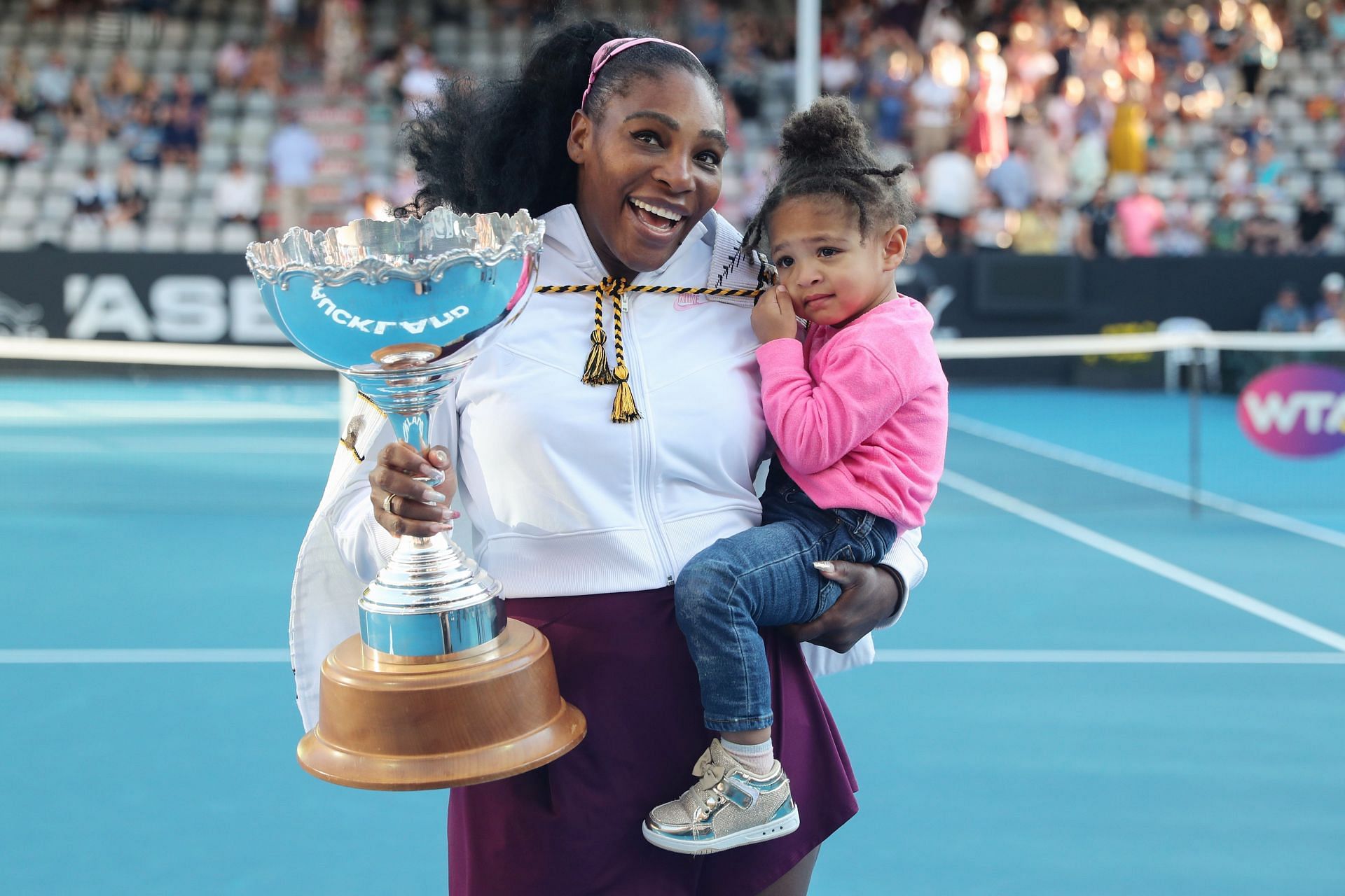 Serena Williams poses with her daughter at the 2020 ASB Classic trophy ceremony