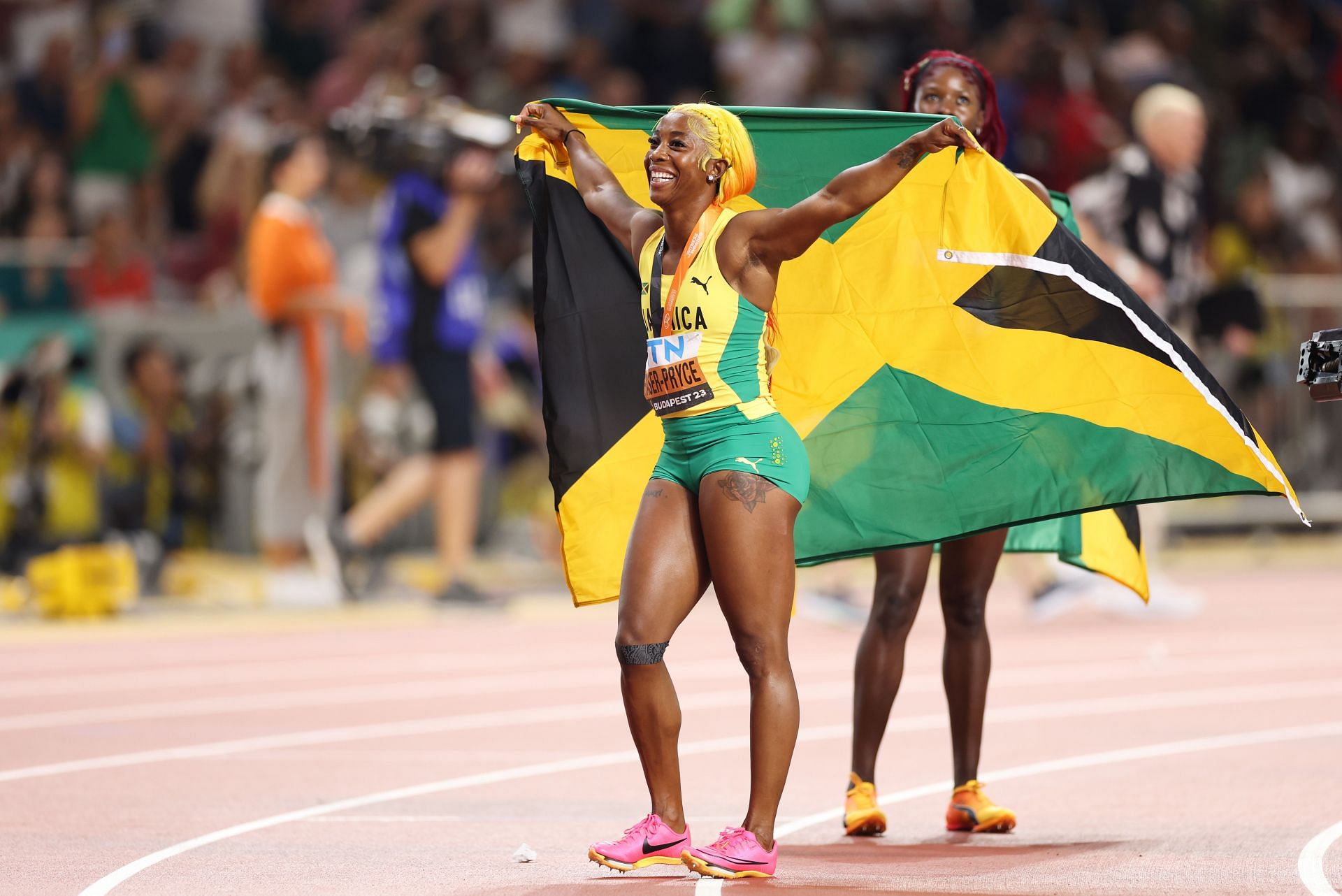 Shelly-Ann Fraser-Pryce poses after winning the women&#039;s 100m at the 2023World Athletics Championships in Budapest, Hungary