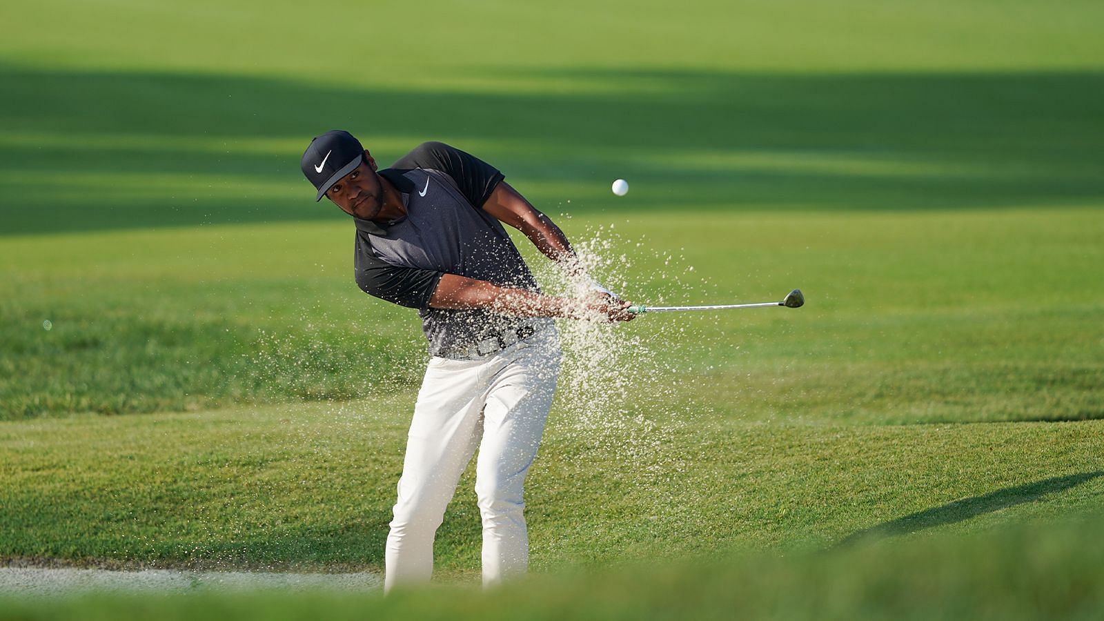 Tony Finau playing a long bunker shot (Image via PGA)