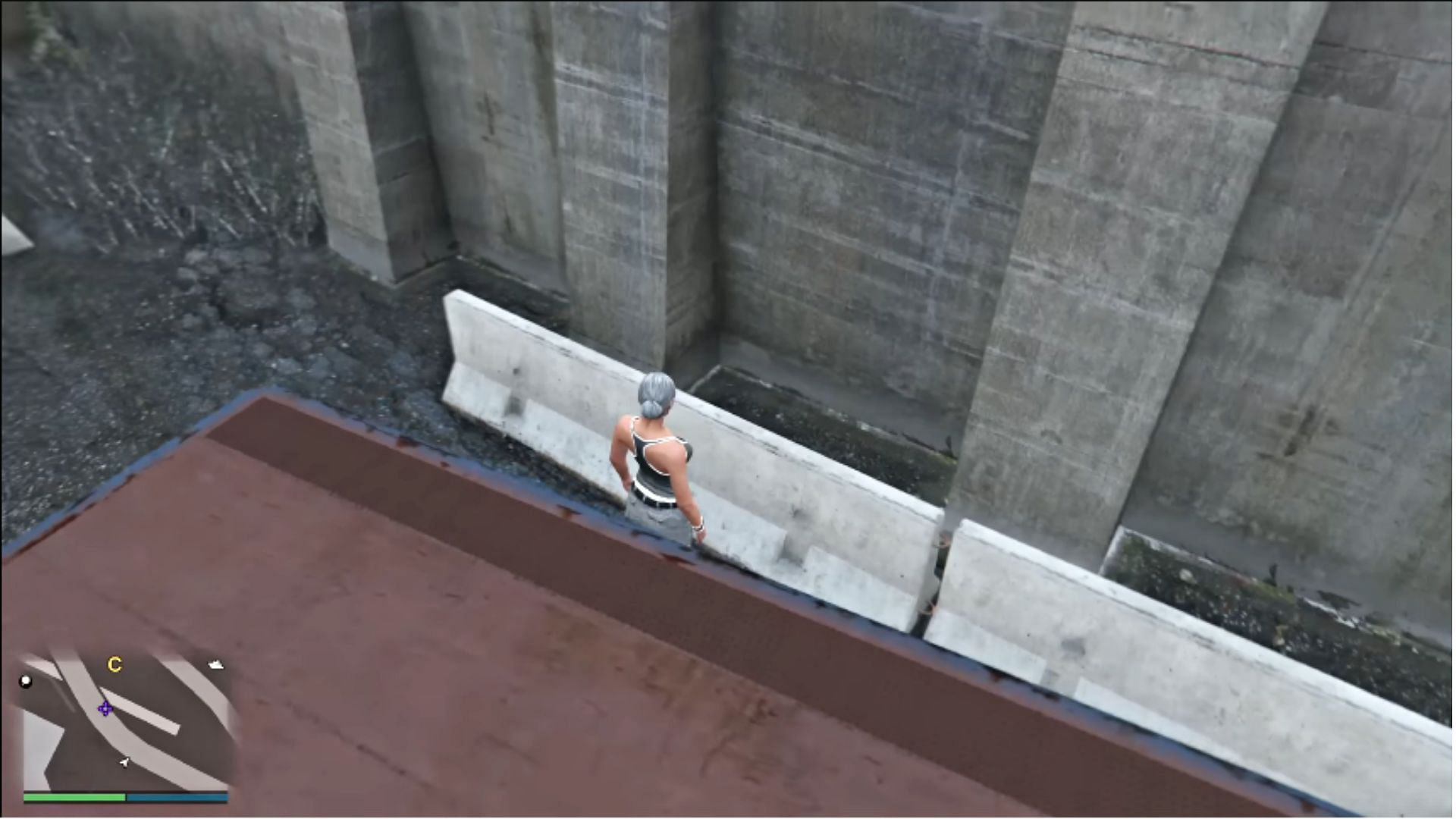 Jump over this concrete barrier and walk left into the wall (Image via YouTube/Matthew Playz)