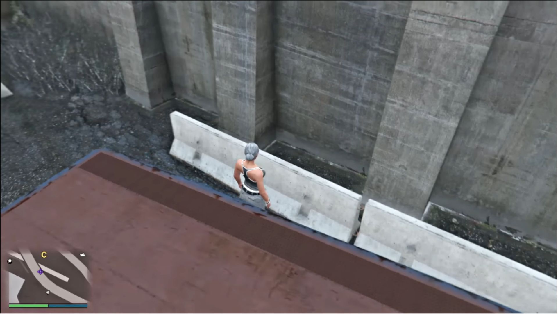 Jump over this concrete barrier and walk left into the wall (Image via YouTube/Matthew Playz)