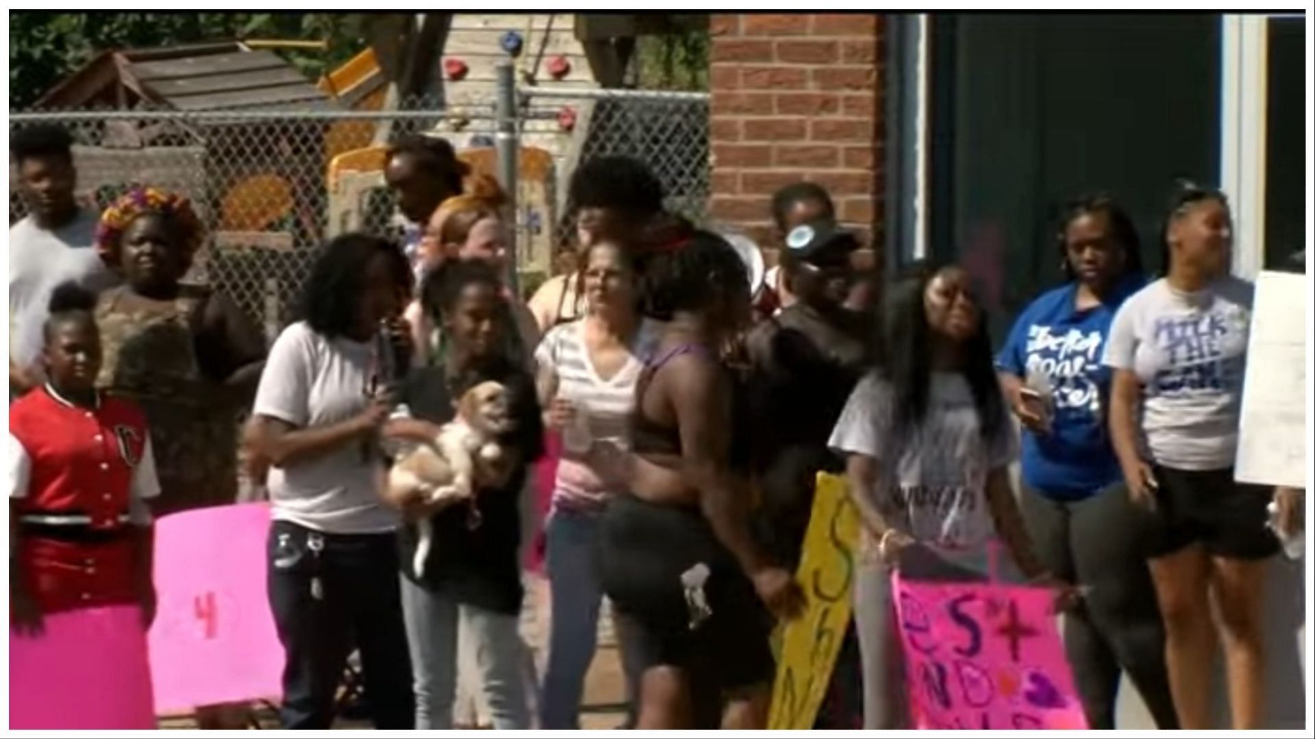 Several family members, friends, and strangers gather to demand justice for the deceased toddler, (Image via KMTV 3 News Now/YouTube) 