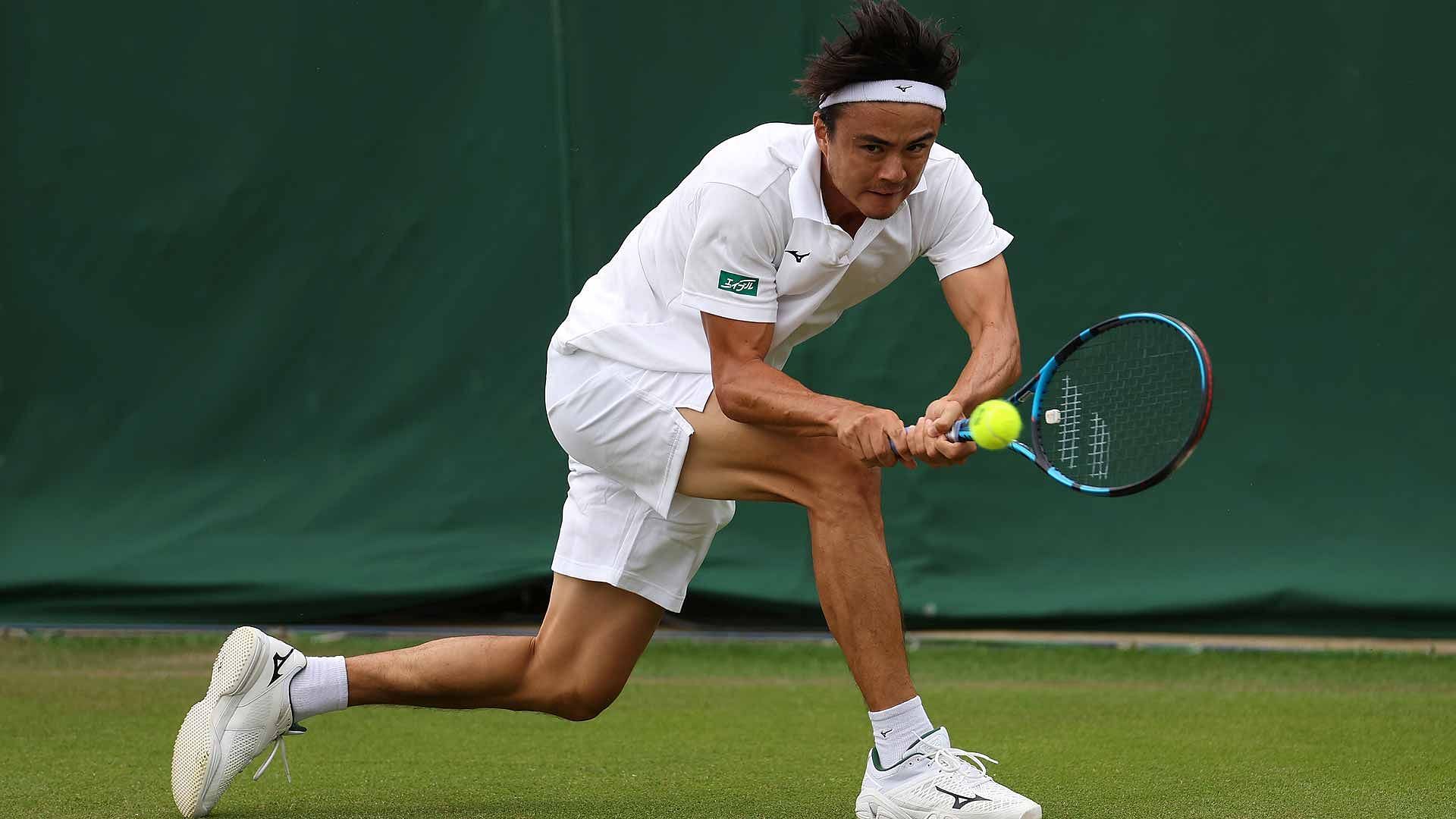 Taro Daniel hits a backhand