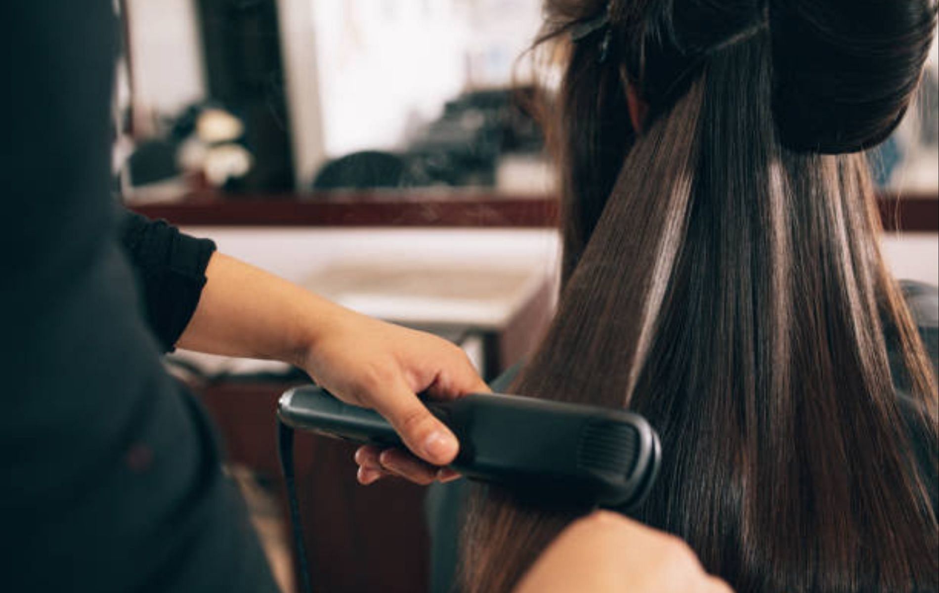 Do adjust the temperature of your flat iron according to your hair strength (Image via iStock)