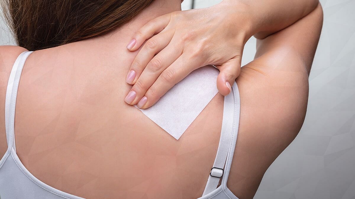 Applying a patch of Lidocaine (Image via Getty Images)