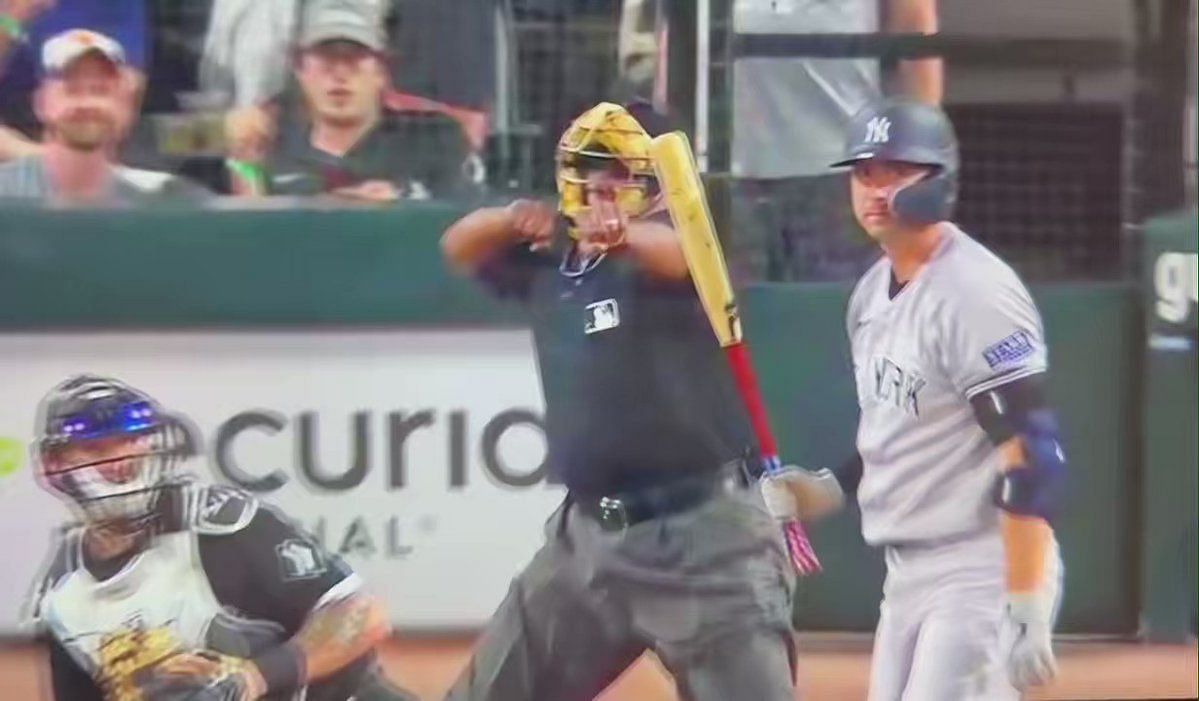 New York Yankees manager Aaron Boone imitates an umpire calling strike  three after arguing with home plate umpire Laz Diaz during the eighth  inning of a baseball game against the Chicago White