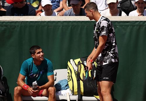 Carlos Alcaraz and Hubert Hurkacz interact with each other.