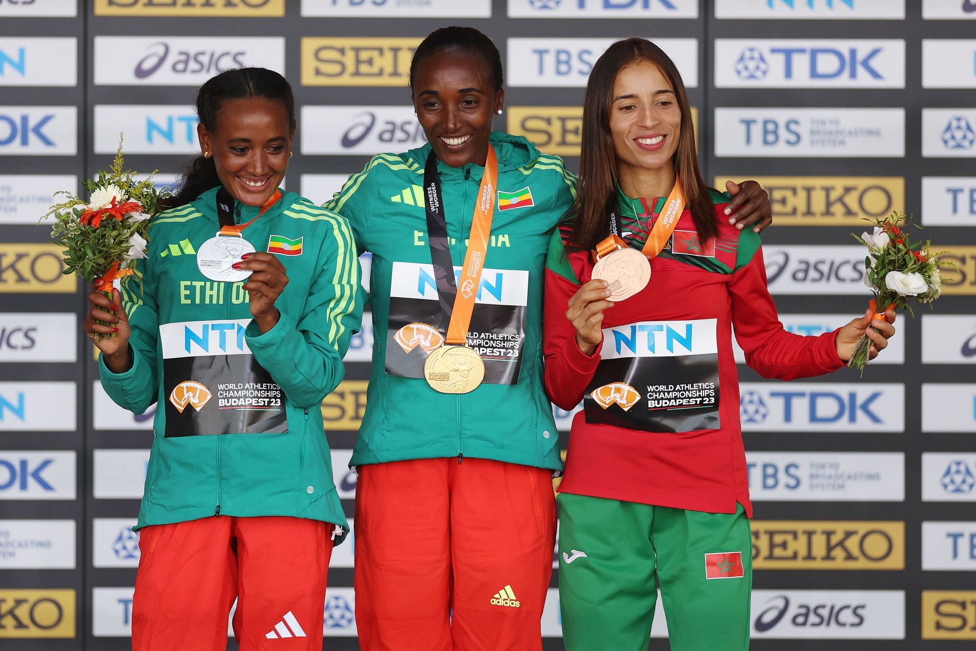 (L-R) Silver medalist Gotytom Gebreslase of Team Ethiopia, Gold medalist Amane Beriso Shankule of Team Ethiopia, and Bronze medalist Fatima Ezzahra Gardadi of Team Morocco pose for a photo during the medal ceremony for the Women&#039;s Marathon during day eight of the World Athletics Championships Budapest 2023