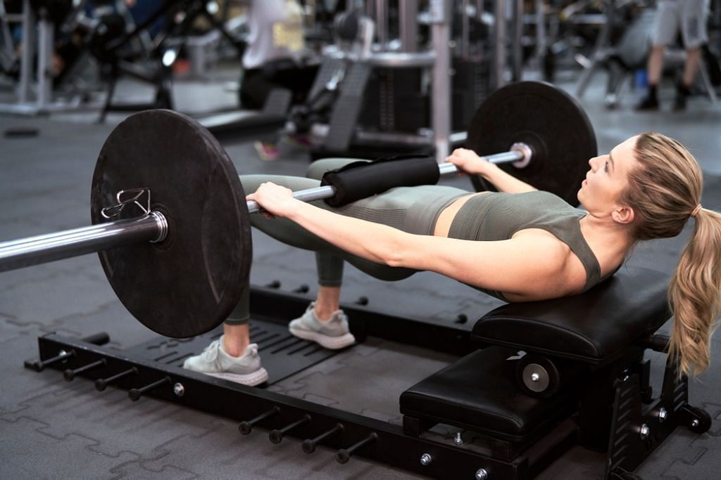 Hip thrusts in a leg day workout (Image via Getty Images)