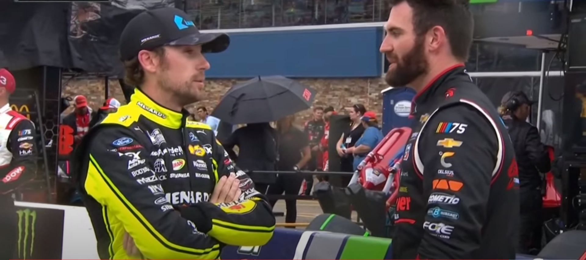 NASCAR Cup Series drivers Ryan Blaney (L) and Corey LaJoie (R) in a conversation during the red flag period during the FireKeepers Casino 400 at Michigan International Speedway. 