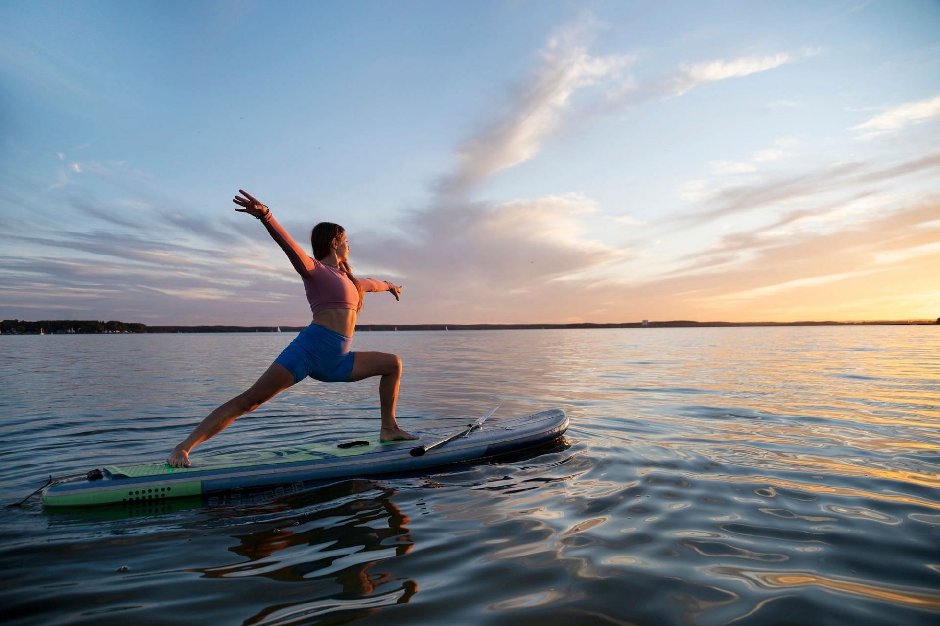 Paddle board yoga. (Image credits: Freepik)