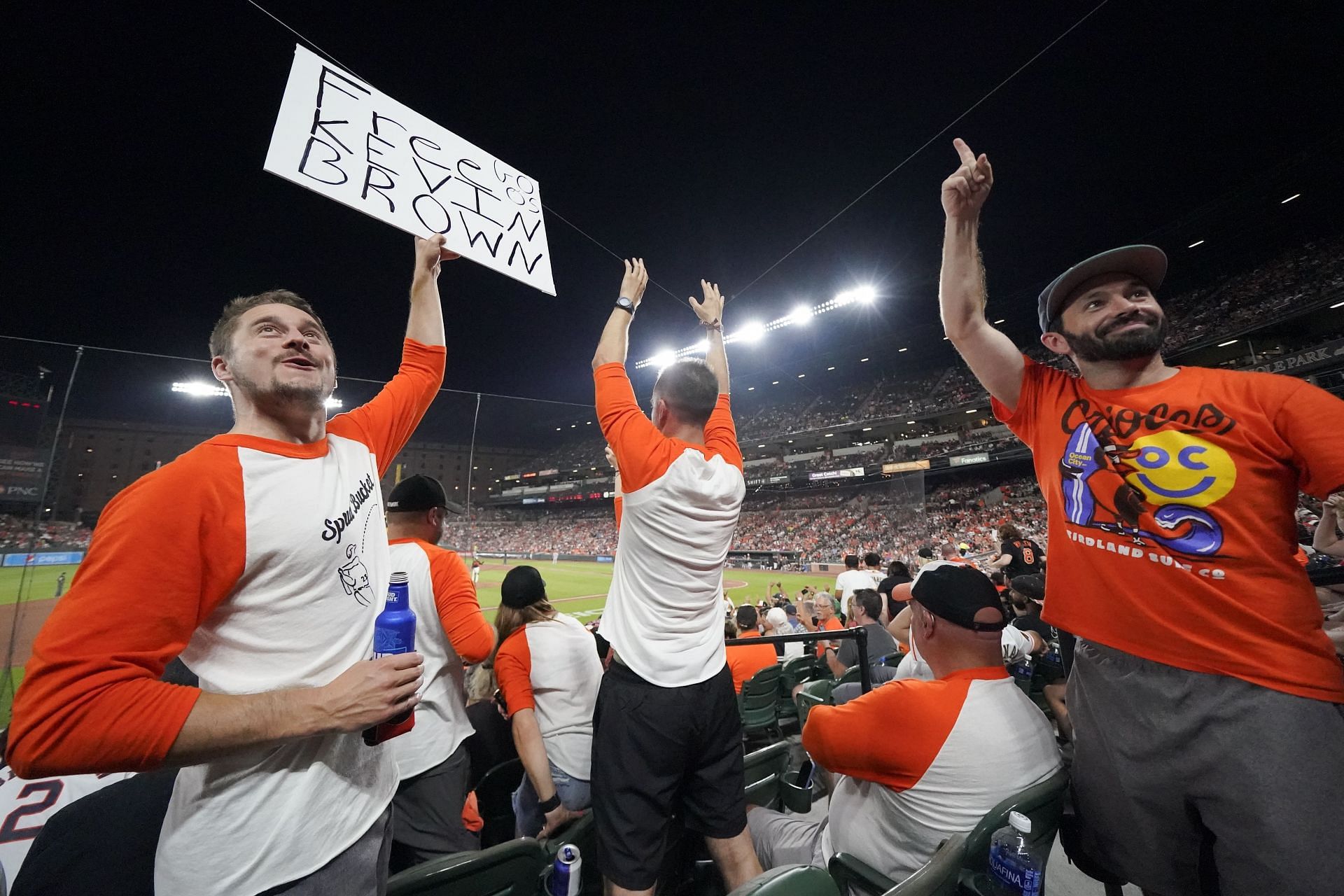 Kevin Tehansky, left, holds a sign in support of broadcaster Kevin Brown in Baltimore.