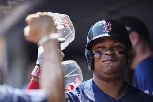 Boston Red Sox's Rafael Devers celebrates with teammates after hitting a home run during a baseball game against the New York Yankees