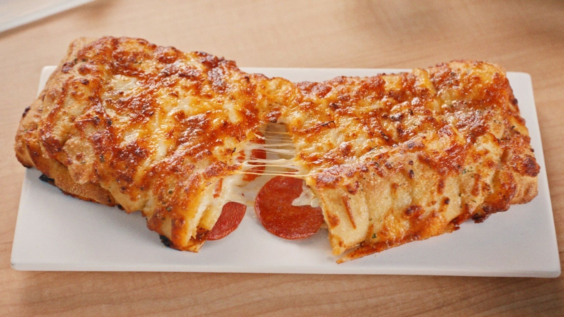 The new Pepperoni Stuffed Cheesy Bread comes loaded with cheese and pepperoni (Imagee via Domino&rsquo;s)