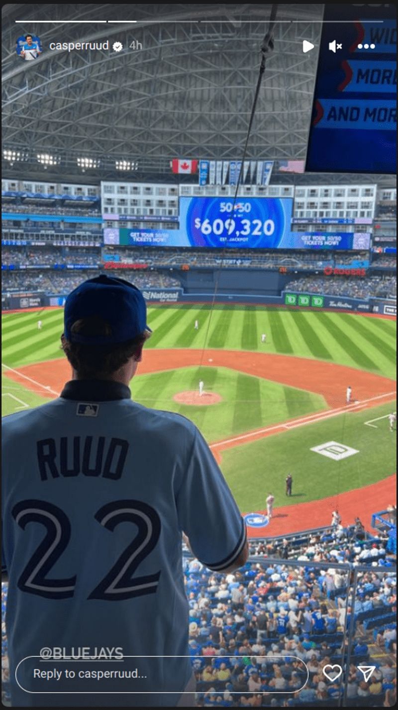 Casper Ruud watches on Toronto Blue Jays match from the stands, donning their jersey