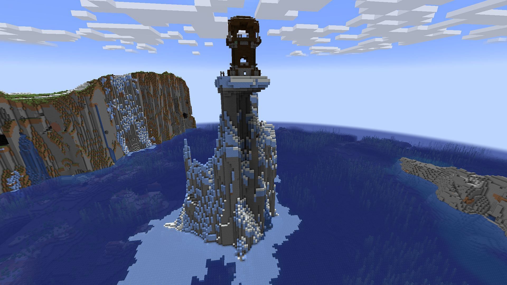 A pillager outpost rests on an ice spike in a Minecraft Java seed.