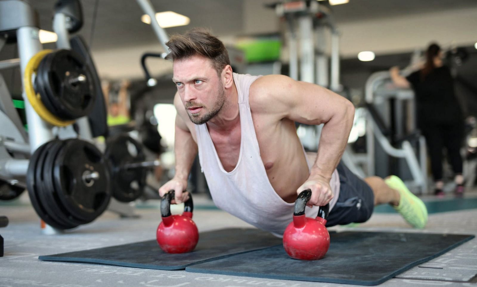 Dumbbell vs. Kettlebell (Image via Getty Images)