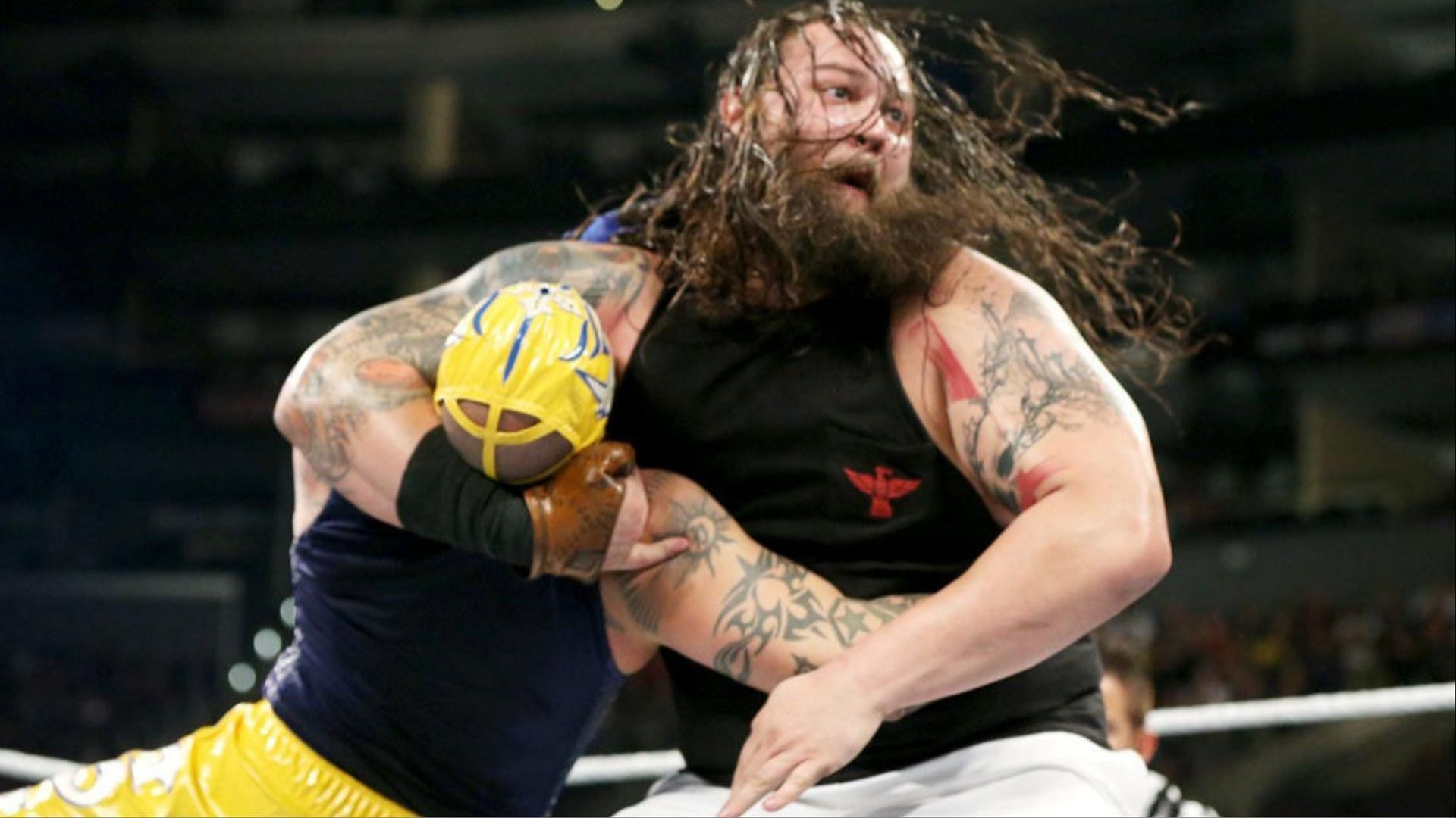 Bray Wyatt hits Rey Mysterio with the Sister Abigail.