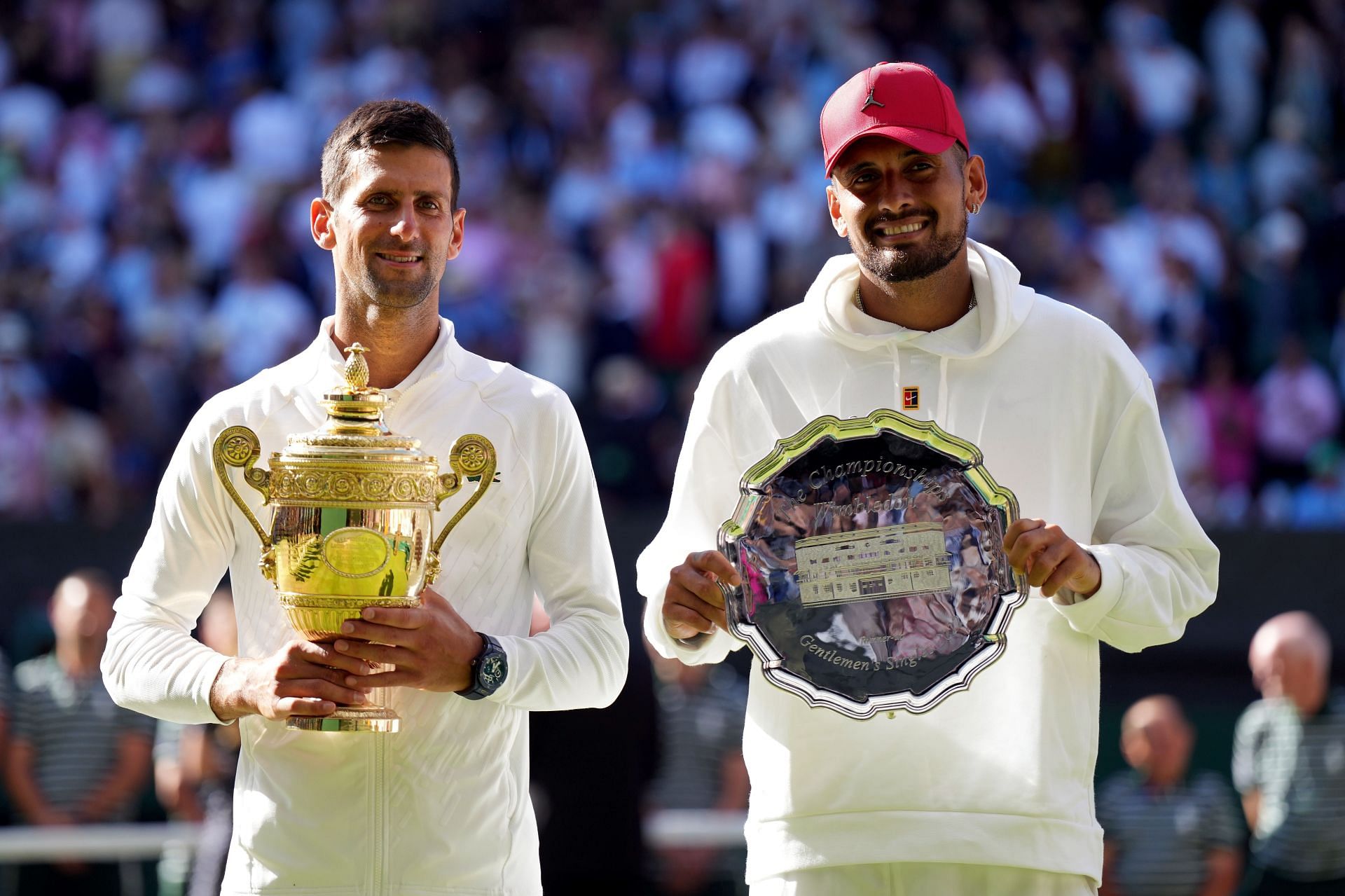 Nick Kyrgios and Novak Djokovic pose at the 2022 Wimbledon trophy ceremony