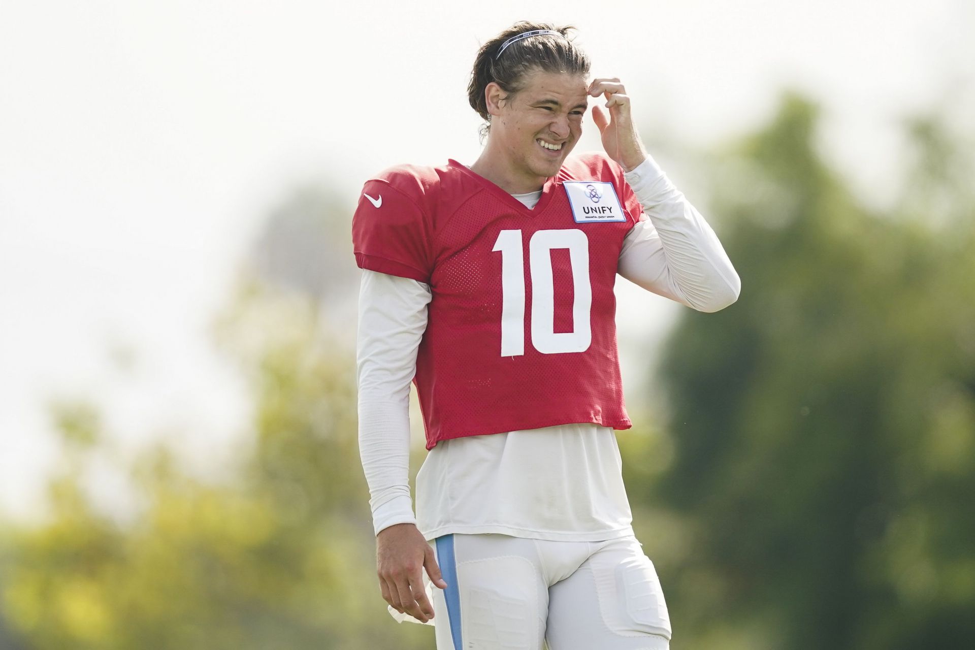 Los Angeles Chargers quarterback Justin Herbert (10) adjusts his helmet as  he warms up before an NFL football game against the Seattle Seahawks Sunday,  Oct. 23, 2022, in Inglewood, Calif. (AP Photo/Marcio