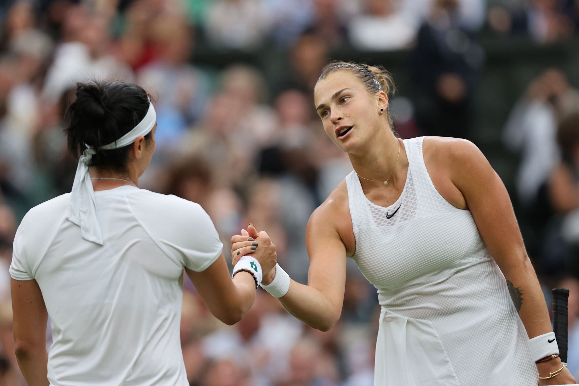 Ons Jabeur and Aryna Sabalenka shake hands after their match at the 2021 Wimbledon Championships