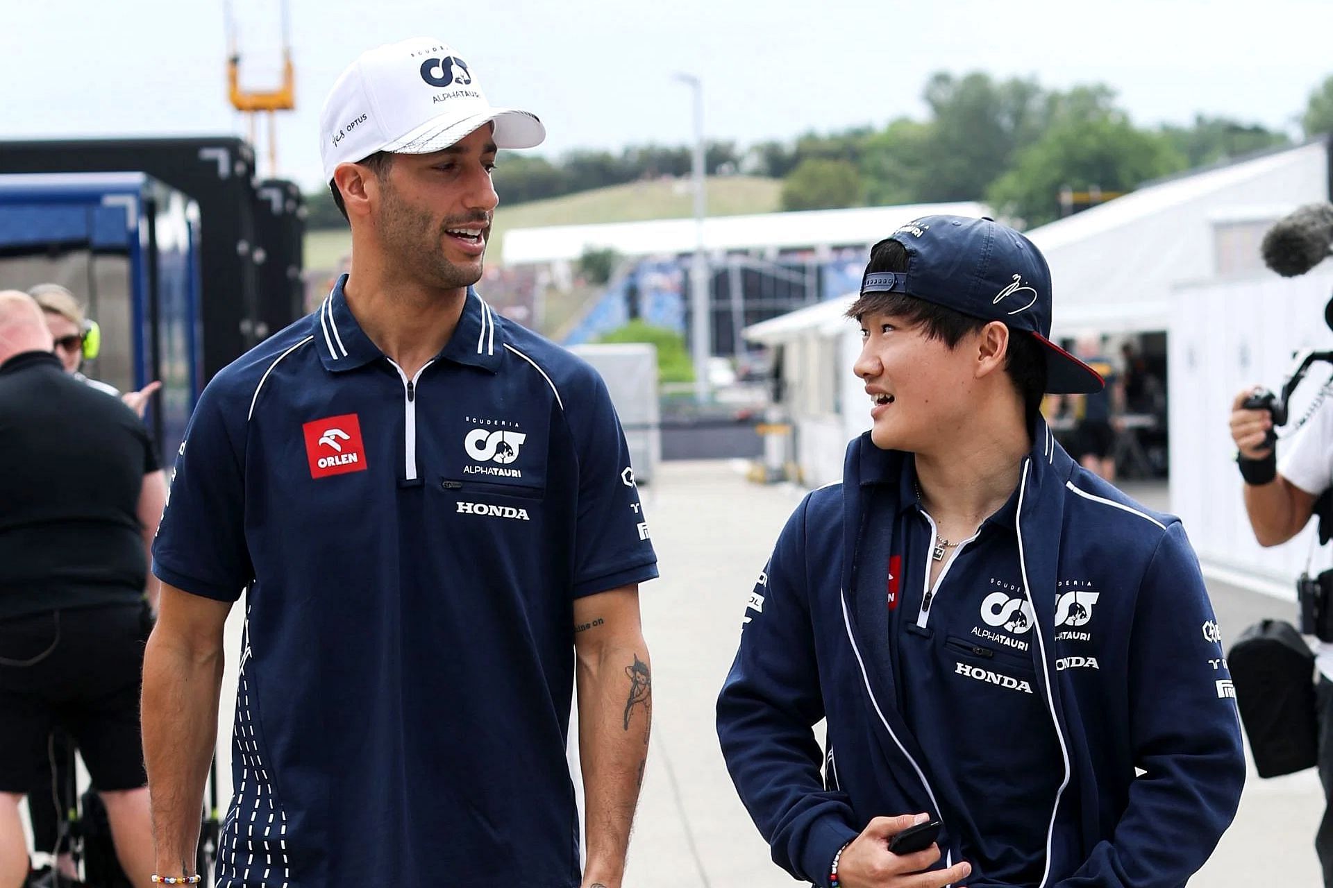 Daniel Ricciardo and Yuki Tsunoda talk in the paddock during practice ahead of the 2023 F1 Hungarian Grand Prix (Photo by Peter Fox/Getty Images)