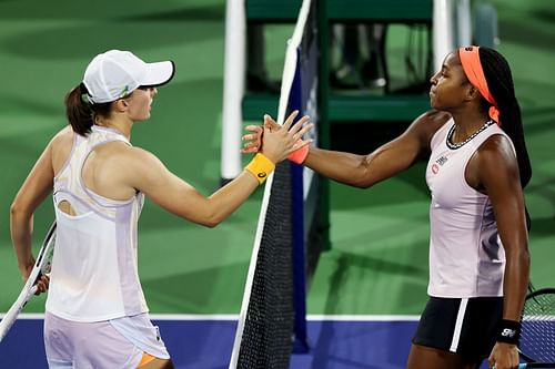 Iga Swiatek and Coco Gauff greet each other at the net.