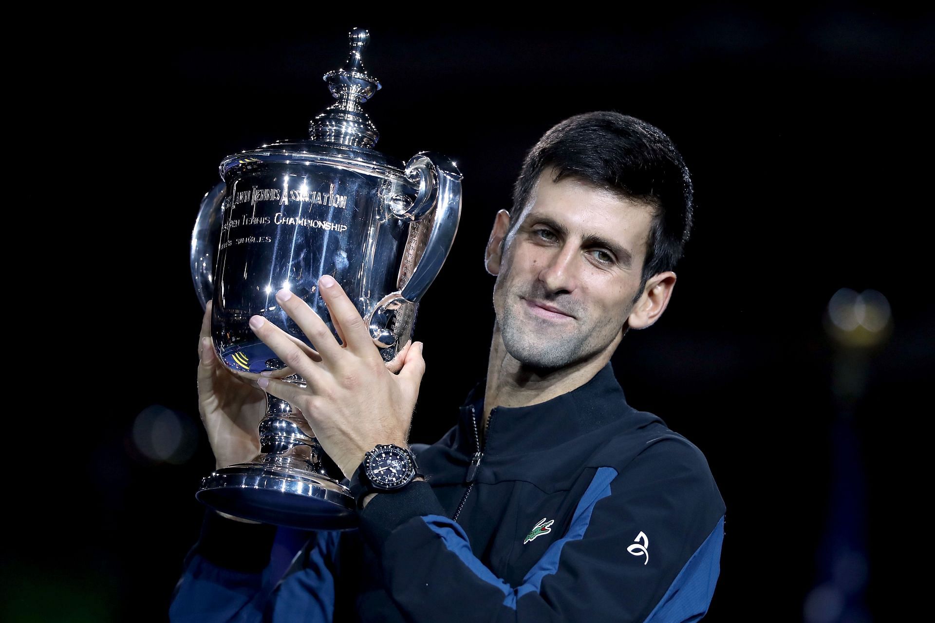 Novak Djokovic poses with the 2018 US Open trophy.