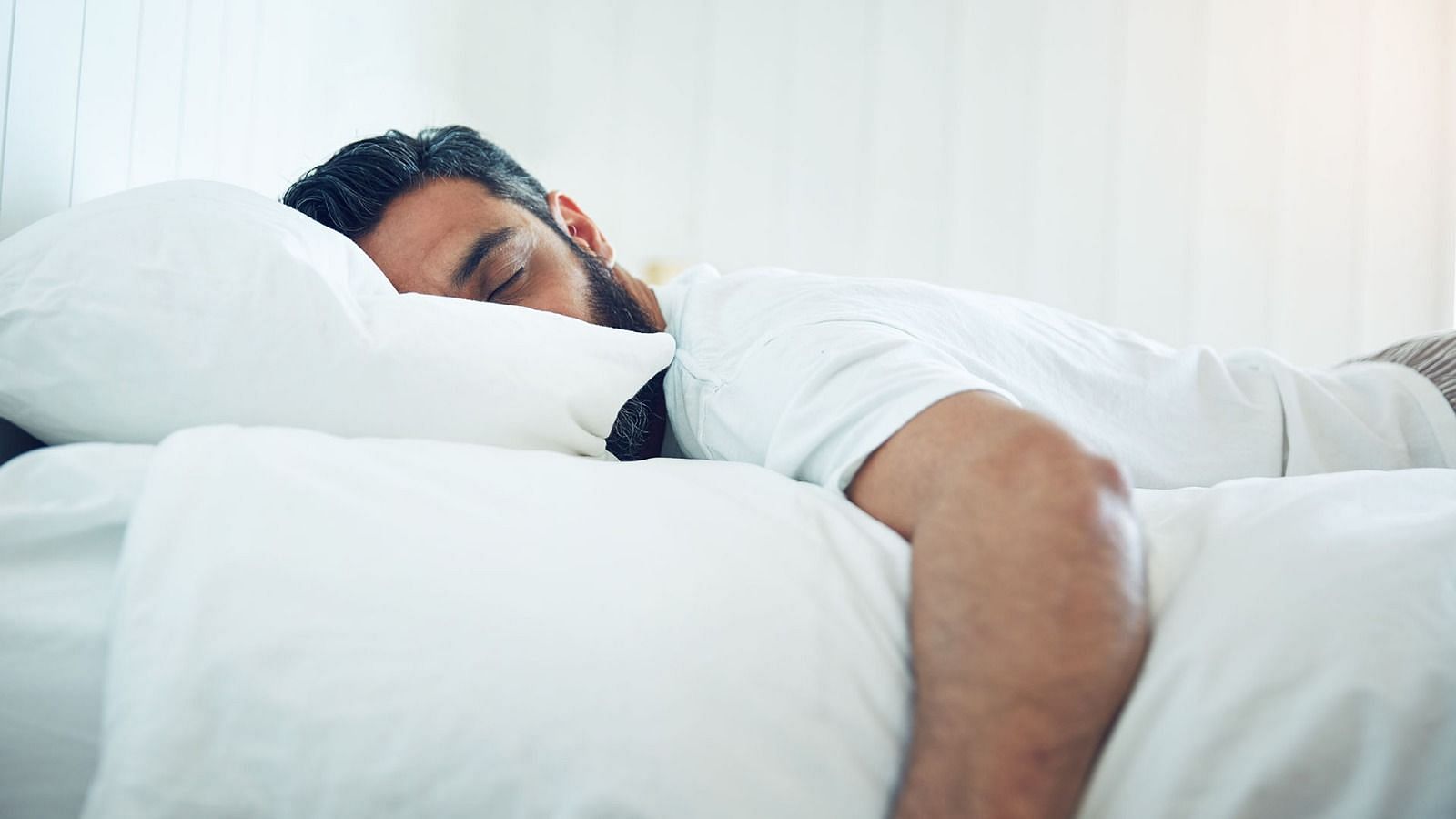 Sleeping on your stomach (Image via Getty Images)