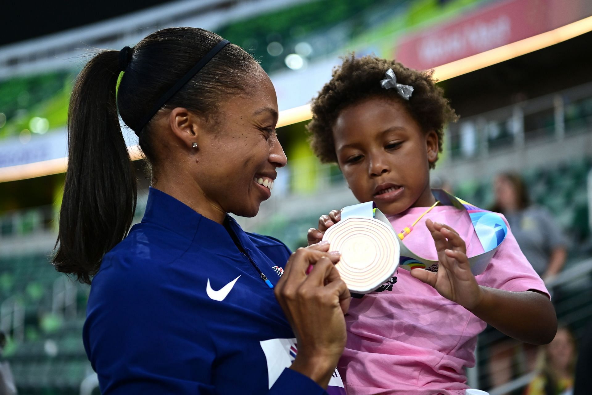 Allyson Felix with her daughter Camyrn after winning a bronze medal in the 4x400m mixed relay at the 2022 World Athletics Championships in Eugene, Oregon
