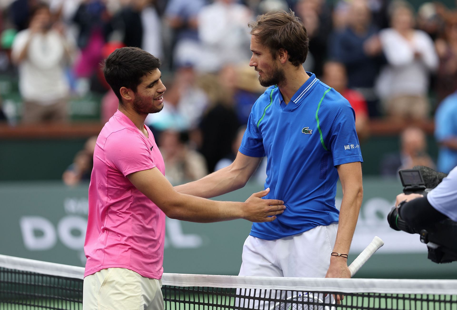 Carlos Alcaraz and Daniil Medvedev greet each other.