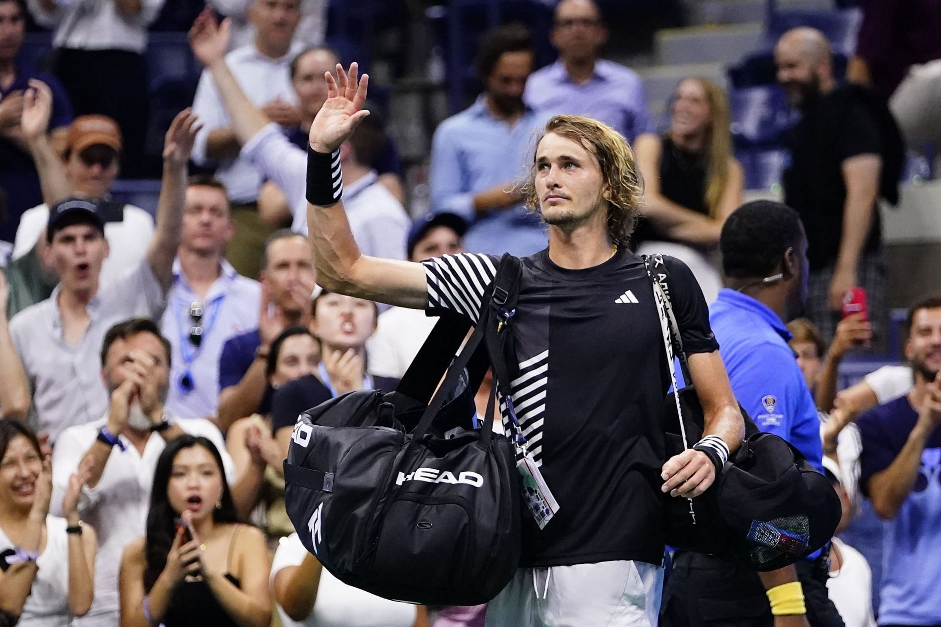 Alexander Zverev waves to the crowd after losing to Carlos Alcaraz in the 2023 US Open quarterfinals.