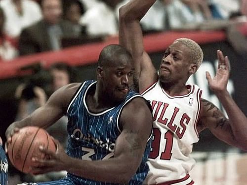 Shaquille O'Neal (left) gets physical with Dennis Rodman