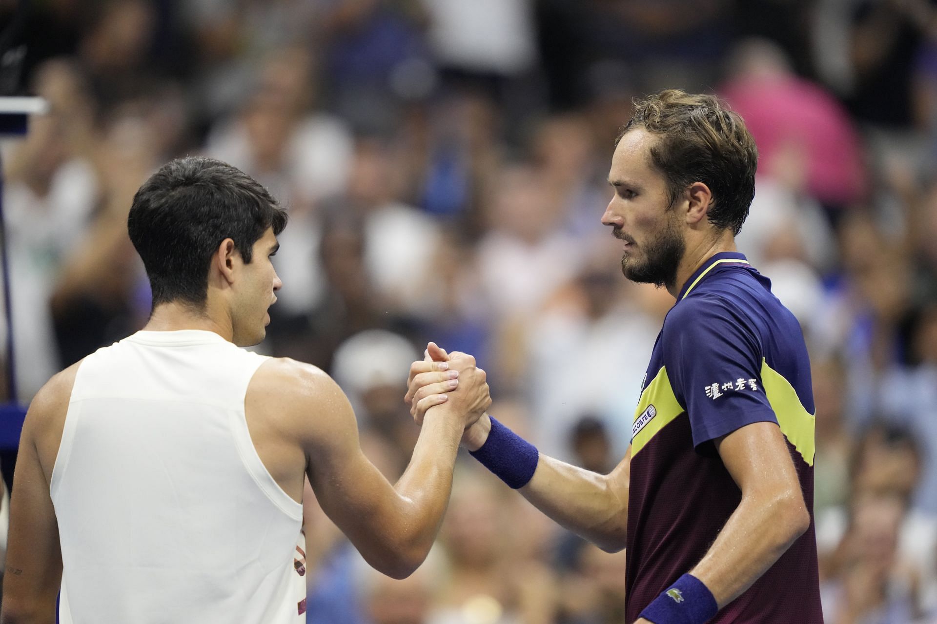 Carlos Alcaraz shakes hands with Daniil Medvedev after their 2023 US Open semifinal match.