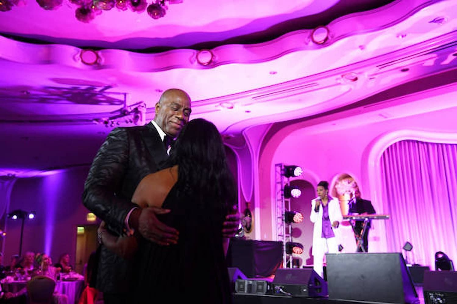 Magic Johnson dancing with wife Cookie Johnson during the Elizabeth Taylor Ball to End AIDS